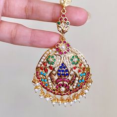 Elevate your bridal look with the timeless elegance and regal allure of our Jadau Teeka. Each piece is expertly crafted by hand in 925 sterling silver, exquisitely set with colorful navratana stones that radiate sophistication. With this traditional design, you'll make a statement that is both refined and enchanting. 22k Gold Jewelry Necklaces, 22k Gold Jewelry, Pearl Necklace Set, Gold Jewelry Necklace, Emerald Necklace, Bridal Look, Gold Bangle Bracelet, Pendant Set, Bridal Looks