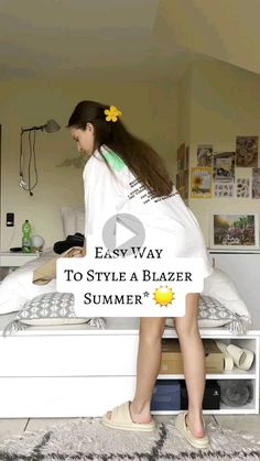 a woman standing on top of a bed next to a white box with the words easy way to style a blazer summer