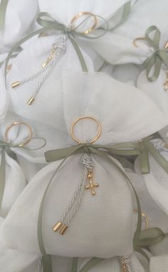 some white and green bags with gold rings on them, tied together in twine