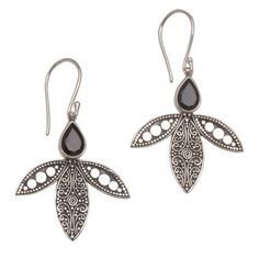 Delicate bun (wirework) and jawan (tiny silver granules) adorn stylized petals on these sterling silver earrings from Bali's Eka Devi. The polished details are heightened by an oxidized background. Gracing the tops of the elegant earrings are faceted onyx gems that total one full carat. Silver Teardrop Earrings With Oxidized Finish As Gift, Sterling Silver Teardrop Oxidized Earrings, Sterling Silver Teardrop Earrings With Oxidized Finish, Traditional Black Sterling Silver Earrings, Traditional Nickel-free Sterling Silver Teardrop Earrings, Onyx Dangle Earrings For Gift, Silver Onyx Oval Jewelry, Elegant Onyx Earrings With Polished Finish, Nickel-free Silver Onyx Earrings