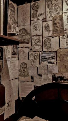 a room with many drawings on the wall and papers all over it that are covering the walls