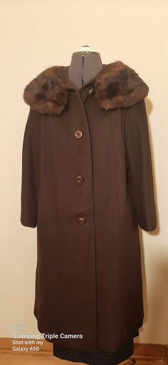 This is a gorgeous wool coat with a faux fur collar and a little swing to the body of the coat, this coat is union-made, but it does not have a maker's name on it.  This coat and lining are in excellent condition. There are four large decorative buttons on the front.  This coat is 18 inches from shoulder to shoulder, 18 inches from underarm to underarm, 20 inches from the shoulder to the end of the sleeve, and from neck to hemline is 35 inches.  Fits size 12 to 14. I do not accept returns, but we can always discuss any problems or concerns before as well as after the sale. Thanks for looking and shopping with me. CoolThenAndNow Classic Brown Wool Coat With Double-breasted Button, Brown Double-breasted Wool Coat With Double Button, Brown Single-breasted Wool Coat, Brown Long-sleeve Wool Coat, Luxury Brown Double-breasted Wool Coat, Pink Prom Dress, Union Made, Decorative Buttons, Black Leather Handbags