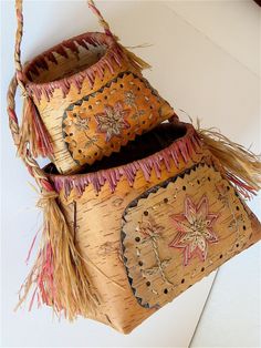 three decorative baskets are stacked on top of each other, one has a star and the other has fringes