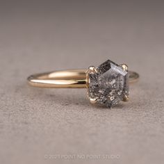 an engagement ring with a rough diamond in the center