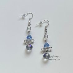 "Handmade Beaded Earrings ✿ Made with glass Czech beads, glass beads, and metal accents ✿ Silver, clear sky blue, iridescent clear, and iridescent deep grey ✿ The earrings are 2.25\" long Fish Hook Options ✿ The Titanium fish hook is hypoallergenic and ideal for sensitive skin ✿ The regular fish hook is made of nickel free metal, it is not hypoallergenic" Silver Dangling Beads Glass Earrings, Silver Glass Earrings With Dangling Beads, Silver Earrings With Dangling Glass Beads, Silver Beaded Earrings With Round Glass Beads, Silver Glass Beaded Dangle Earrings, Silver Crystal Earrings For Jewelry Making, Adjustable Silver Glass Beaded Earrings, Silver Glass Drop Crystal Earrings, Stolen Image