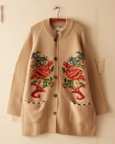 This jacket is inspired by a crochet blanket, circa 1850s-1870s. It features a faithful reproduction of the original motif reinterpreted as a knit with hand-embroidered details.  Elongated fit Four button closure  Two front pockets 100% wool   Made in Peru Dry clean only View all knitwear All wear, mending, and idiosyn Winter Floral Embroidery Long Sleeve Cardigan, Winter Floral Embroidered Knit Cardigan, Beige Jacquard Knit Long Sleeve Outerwear, Embroidered Knit Long Sleeve Outerwear, Embroidered Knit Cardigan For Fall, Bohemian Winter Sweater With Floral Embroidery, Beige Winter Cardigan With Floral Embroidery, Beige Floral Embroidered Winter Cardigan, Beige Cardigan With Floral Embroidery For Fall