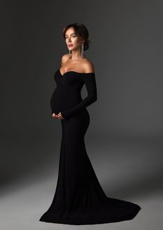 The Scarlet Gown features a fitted cut with an off the shoulders, long sleeves top. This comes with a shorter train, more suitable for studio use. MATERIAL / Stretchy Knit COVERAGE / Fully Line PROCESSING TIME / 2-3 WEEKS Black Formal Dress Maternity, White Outfit Maternity Photos, Maternity Photography Black Dress, Black Maternity Dress Photoshoot, Pregnant Evening Dress, Black Dress Maternity Pictures, Black Maternity Pictures, Elegant Maternity Photos, Maternity Evening