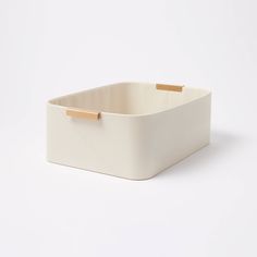 a white rectangular container with gold handles