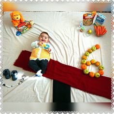 a baby is laying on a blanket with toys