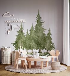 a table and chairs in front of a wall with trees painted on the wall behind it