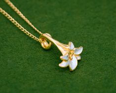 The lily is an iconic flower synonymous with summer. The gentle curves and subtle finish of this flower design gives this series an elegant and timeless look. With a base of high purity silver and plated with 23K Gold, the gold has been partially scraped away to reveal the silver underneath. The Silver-only version has also been partially scraped to create the contrast in textures. Pendant length: approximately 21mm Chain length: 40cm (15.8 in), 45cm (17.7 in) or 50cm (19.7 in) Pendant material: Lilly Necklace, Japanese Pendant, Small Diamond Necklace, Necklace Japanese, Small Gold Necklace, Lily Jewelry, Necklace Tattoo, Lily Necklace, Japanese Jewelry