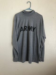 "ARMY t shirt, 90s ARMY grey gray t shirt Measurements: 45\" chest/bust, 29\" length CONDITION: Very worn in stains Cotton/Polyester Made in USA" Khaki Long Sleeve T-shirt For Streetwear, Military Style Long Sleeve Tops For Fall, Black Military Long Sleeve Tops, Winter Military Long Sleeve Tops, Black Long Sleeve Military Top, Winter Military Style Long Sleeve Tops, Military Style Crew Neck Tops For Fall, Fall Military Crew Neck Tops, Military Style Long Sleeve Cotton Tops