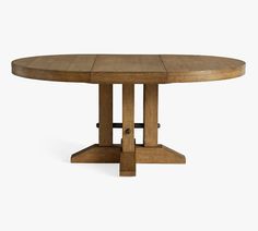 an oval wooden table with two pedestals on each side and one leg raised up