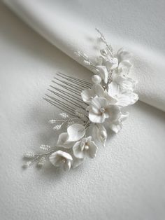 Floral bridal haircomb. Beautiful bridal hair comb, crafted with ivory clay flowers and leaves, embellished with freshwater pearl twigs. The haircomb measures approx 11-12cm x 3.5cm. Available in silver, gold or rose gold colour wire. Order processing time has been extended due to high number of orders, so please DM if you need it posted sooner. As each of our pieces is handmade especially for you, we are unable to accept returns/exchanges Magnolia Hair Piece Bridal, Floral Hair Comb Wedding, White Floral Hair Piece, Eucalyptus Hair Comb, Fresh Floral Hair Comb, Bridal Hair Comb Side Floral, Beautiful Bridal Hair, Floral Hair Combs, Hair Comb Wedding