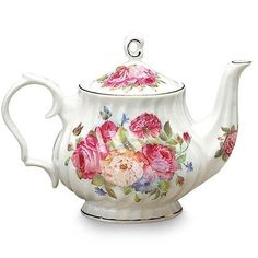 a tea pot with flowers painted on it