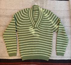 Cute 1960's wool sweater. Hand crocheted and is very soft and comfortable. The colors are also very nice and vivid, the green is like pea color and the stripes are a soft off white. In very good condition, it does have a few imperfections there is a small spot in the front and it seems there was a small repair over the right shoulder, its hard to tell at first. Fits a S/M measurements are listed below.  Shoulder to Shoulder: up to 20" Armpit to Armpit: 18"-20" Shoulder to Hem: 25" Sleeve Length: Retro Striped Knitted Sweater, Retro Green Cotton Sweater, Retro Green Winter Tops, Green Retro Winter Tops, Retro Green Winter Sweater, Green Retro Winter Sweater, Vintage Striped Cotton Sweater, Retro Green Knitted Sweater, Fitted Green Wool Sweater