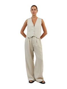 The Sleeveless Linen Vest Pant Set is a timeless ensemble that ties sophistication with comfort. This set is composed of a sleeveless linen vest that boasts a sharp V-neckline and button-down front, paired with coordinating wide-leg pants that offer a relaxed fit. This set encapsulates an effortless elegance, ideal for those who appreciate a minimalist aesthetic with a touch of classic charm! Features: Light & Soft Linen A lightweight textured linen material with soft lining adapts to any style Linen Vest For Daywear, Sleeveless Linen Vest For Daywear, V-neck Linen Vest For Workwear, Elegant Linen Tank Top For Work, Classic Sleeveless Bottoms For Spring, Chic V-neck Linen Vest, Elegant Beige Linen Vest, Linen Vest, Vest Set