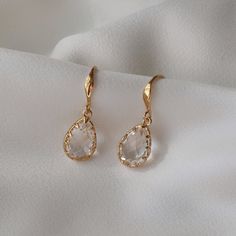 🤍 BLANCA PETITE Gold Crystal Dropper Earrings 🤍 Petite version of our best selling Blanca earrings.  The Blanca petite earrings are stunningly sparkly crystal drop earrings, a perfect addition to any outfit. The white crystal teardrop is encased with a gold edging & then added to a subtle gold ear hook. Available in 14ct gold vermeil or sterling silver. Details: 14ct gold vermeil or sterling silver White crystal  Crystal size 13mm x 9mm ♻️Sustainable jewellery - our jewellery is made with recycled metals and responsibly sourced stones. If you would like some help choosing your bridal accessories, please get in touch with us and we will be happy to help.  Deborah K Design is an award winning bespoke bridal accessories designer based in the UK, offering worldwide shipping. Our collections Feminine Wedding Earrings, Drop Bridal Earrings, Gold Teardrop Earrings, Gold Minimalist Jewelry, Earring Stack, Petite Earrings, Gold Earrings Wedding, Earrings Minimal, Bridal Earrings Drop