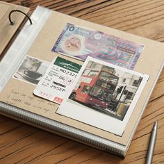 an open planner book sitting on top of a wooden table