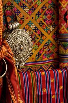 colorful fabrics and accessories on display in a store window, with the focus on the purse