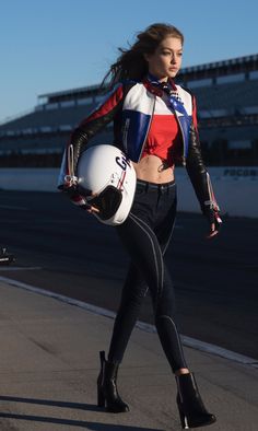 a woman in black and red is holding a white helmet