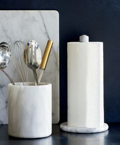 marble utensils in a white cup on a counter