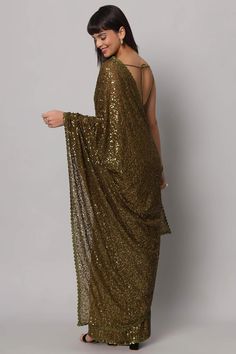 Unveil the allure of the night with our Mehandi Sequins Embroidery Georgette One Minute Saree. In the enchanting shade of Olive Green, this saree isn't just a garment; it's a enchanting story woven in Georgette, adorned with a mesmerizing cascade of Heavy Sequins that shimmer like stars in the midnight sky. No trims needed when the saree itself is a masterpiece. The blouse, crafted from the same fabric, features thin straps and a Deep U neckline, ensuring you're draped in sheer elegance that lea Bridesmaid Sarees, One Minute Saree, Embroidery Work Saree, Formal Saree, Saree With Belt, Floral Print Sarees, Saree Sale, Party Wear Saree, Georgette Blouse