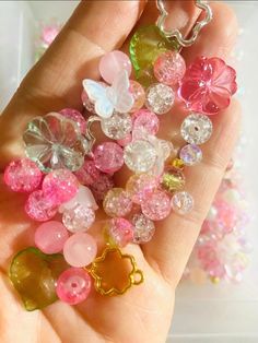 a hand holding a bunch of different colored beads