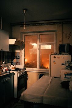 a kitchen with an oven, refrigerator and window