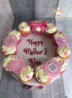 a mothers day cake with cupcakes in the shape of a heart on top