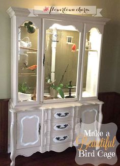 an old china cabinet is painted white with black trim and flowers in the glass doors