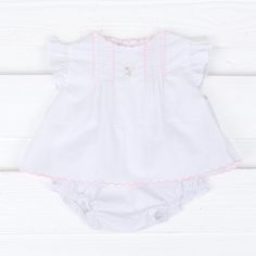 This Bloomer Set with Pink Embroidered Flowers is a delightful outfit with sweet and special details! Featuring pleats, ruffled sleeves, and charming pink embroidery, this set is sure to make your little one stand out. White Ruffled Cotton Sets, White Cotton Ruffled Sets, White Cotton Sets With Ruffles, Cute Spring Daywear Sets, Cute White Floral Embroidered Sets, Cute Daywear Sets For Spring, Cute White Sets With Floral Embroidery, Cute White Sets With Lace Trim, Cute White Floral Embroidery Sets