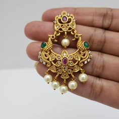 This beautiful earrings set has an excellent finish and gives out an exquisite sense of style. If you are looking for an amazing Fashion Jewelry set for special occasions such as Anniversary, Engagement, Party, Wedding, or for gifting, then your search ends here. Handmade Indian Temple Jewelry, best to wear it for traditional ceremonies or Indian wedding. This bridal jewelry has an ethnic finish. It has Cubic Zircon stones with semi-precious ruby and emeralds. It is a Bollywood style one gram je Traditional Jewelry Sets For Reception With Matching Earrings, Elegant Festive Pearl Drop Tikka, Elegant Chandbali Bridal Necklace With Peacock Design, Elegant Pearl Drop Tikka For Festive Occasions, Elegant Chandbali Bridal Necklace With Matching Earrings, Elegant Bridal Chandbali Necklace With Peacock Design, Gold Plated Chandbali Jewelry Sets, Gold Chandbalis With Peacock Design In 22k Gold, Temple Jewelry Chandbali Bridal Earrings With Elegant Design