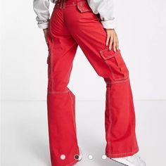 Elevate Your Wardrobe With These Stylish Asos Design Red Belted Cargo Flare Pants. Perfect For Any Fashion-Forward Woman, These Pants Come In A Vibrant Red Color And Feature A Flared Leg Style. The Cargo Style Adds A Touch Of Functionality To The Pants With Multiple Pockets To Store Your Essentials. The Belted Waistline Accentuates Your Curves And Creates A More Flattering Silhouette. Size 6 New Without Tags, Adjustable Belt, Great For All Seasons. Measurements: Ankle Opening 11 Inches 30 Inch I Red Wide Leg Parachute Pants For Streetwear, Casual Red Parachute Pants For Spring, Red Cotton Wide Leg Parachute Pants, Red Wide Leg Cotton Parachute Pants, Red Full Length Streetwear Pants, Red Full Length Pants For Streetwear, Red Full Length Cotton Cargo Pants, Red Full-length Cotton Cargo Pants, Red Full-length Parachute Pants With Pockets