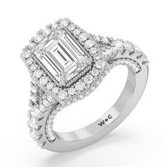 a white gold ring with an emerald cut diamond surrounded by smaller diamonds