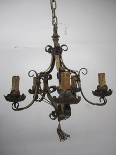 an old chandelier hanging from the ceiling