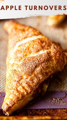 an apple turnover sitting on top of a baking sheet with the words apple turnover over it