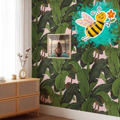 a room with a wallpaper that has a bee on it and some green leaves