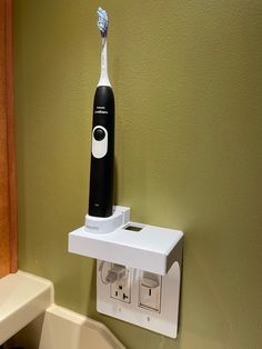 an electric toothbrush is mounted to the wall