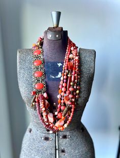 As we head into fall, I am still focused on incorporating as much color as possible into my style of work. How fun in this stunning yet bright piece?!  This piece has all the wonderful colors of fall from muted tones of red orange to dark topaz!  I have found that my creative mind is loving to work with the same colors for a few pieces and then change it up as I go to another.  On the top left side is a stunning vintage Sarah Coventry repurposed coral lucite piece repurposed into this big beaded Necklace Long Gold, Necklace African, Gold Long Necklace, Handmade African, Necklace Red, Muted Tones, Coral Necklace, Sarah Coventry, Creative Mind