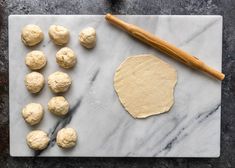 doughnuts and rolling pin on a marble board