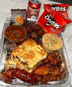 a tray filled with food and condiments on top of a table