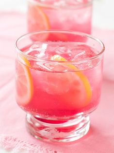 two glasses filled with pink lemonade on top of a table