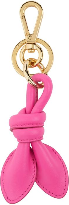 a pink leather key chain with two gold rings