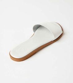 Elevate your style effortlessly with the simplicity of chic fashion in these versatile slide sandals, allowing you to pair them with anything from casual denim to a breezy summer dress. Whether you're strolling through the city streets or enjoying a leisurely day at the beach, these comfortable leather sandals are made for your every adventure. 100% Leather Imported Soft pillow sole Runs small and narrow; we recommend sizing up Rub with dry cloth | Karen Kane Leather Sandals in White, Size 36, P Comfortable Leather Sandals, Soft Pillow, Karen Kane, Day At The Beach, Soft Pillows, Chic Fashion, Sandal Fashion, Casual Denim, City Streets