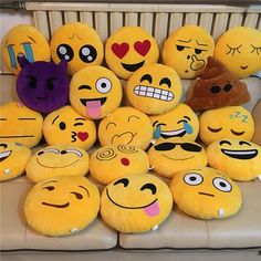 a pile of smiley face pillows sitting on top of a couch