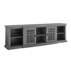 an entertainment center with two doors and three shelves on one side, in grey color