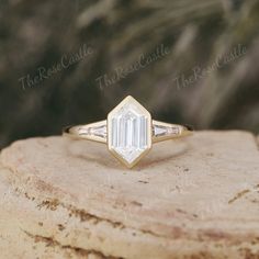 a diamond ring sitting on top of a rock