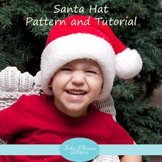 a little boy wearing a santa hat and smiling