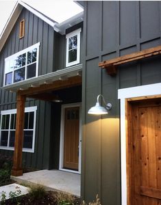 an instagramted photo of a house with wood doors